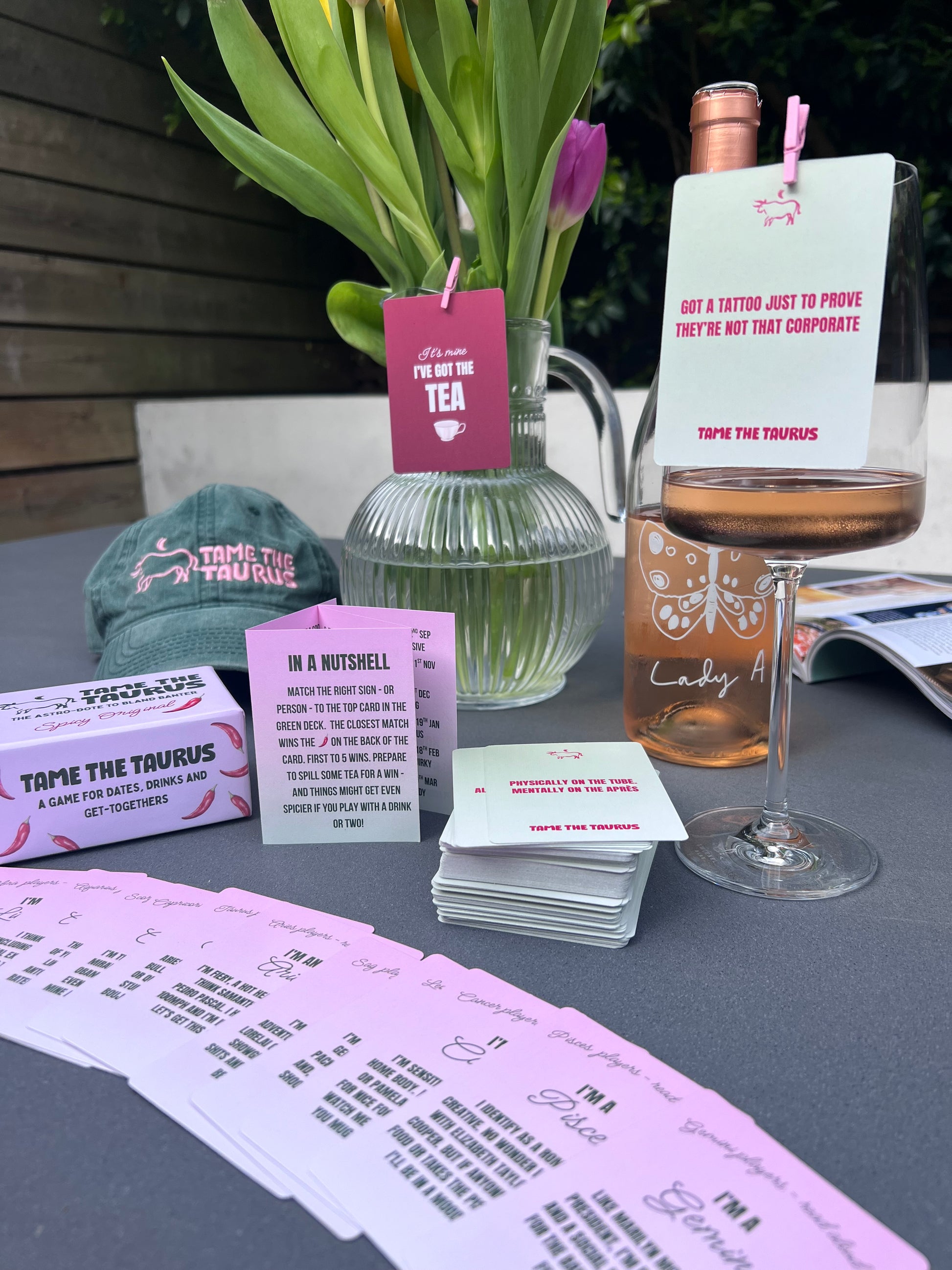 an image that shows astrology game, Tame the Taurus, with all it's components as a party game that's perfect for dates, dinner parties, hens and get togethers